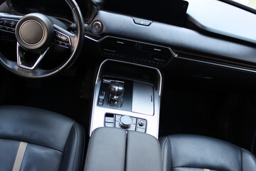  Steering wheel, armrest and  seats is finished by expensive leather upholstery in car interior 

