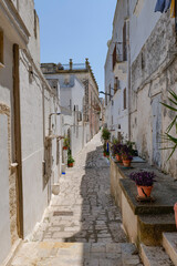 A narrow street among the white houses of Ginosa, an Apulian village, Italy.