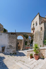 A narrow street among the white houses of Ginosa, an Apulian village, Italy.