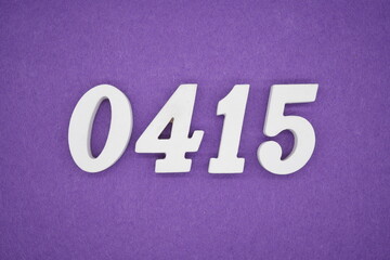 The numbers are made of white painted wood, placed on a purple paper background.