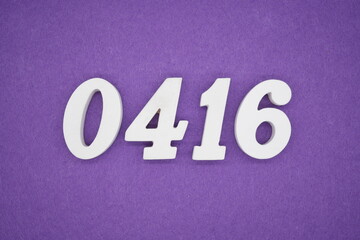 The numbers are made of white painted wood, placed on a purple paper background.