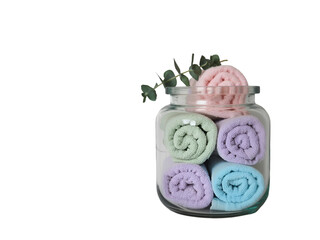 Rolled towels in a glass jar with eucalyptus isolated on a transparent background image