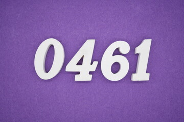 The numbers are made of white painted wood, placed on a purple paper background.