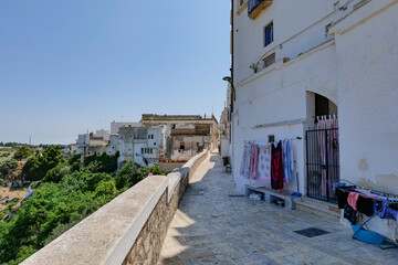 A narrow street among the white houses of Ginosa, an Apulian village, Italy.