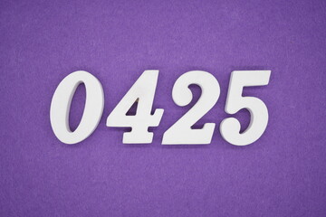 The numbers are made of white painted wood, placed on a purple paper background.