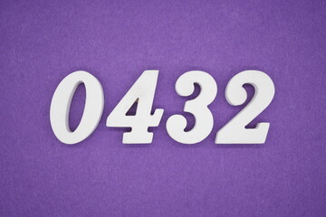 The numbers are made of white painted wood, placed on a purple paper background.