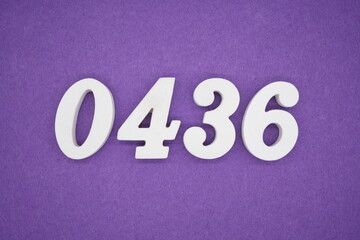 The numbers are made of white painted wood, placed on a purple paper background.