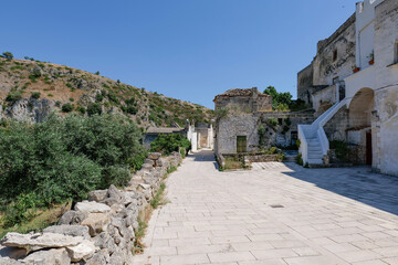 A narrow street among the white houses of Ginosa, an Apulian village, Italy.