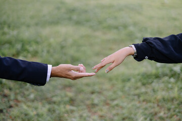 Closeup of a man and woman's hands reaching out to connect, a concept of love, support, and tender...