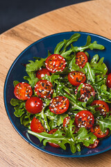 Salad with arugula, cherry tomatoes and olive oil