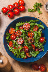 Salad with arugula, cherry tomatoes and olive oil
