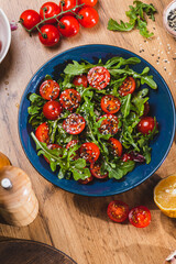 Salad with arugula, cherry tomatoes and olive oil