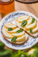 Bruschetta with ricotta and nectarines, garnished with honey and basil