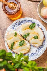 Bruschetta with ricotta and nectarines, garnished with honey and basil