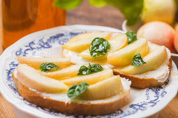 Bruschetta with ricotta and nectarines, garnished with honey and basil