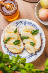 Bruschetta with ricotta and nectarines, garnished with honey and basil