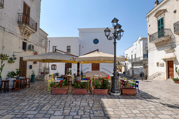 A small square among the white houses of Gravina, a village in Puglia, Italy.