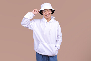 Asian Model Posing in a White Bucket Hat and Hoodie for Design Mockups on Beige Background