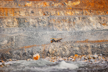 Banner Industrial Mining Operations with Heavy big yellow trucks in open pit mine of gold, copper,...
