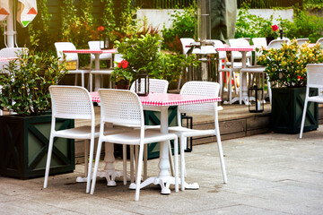 Chairs and tables. Abandoned sidewalk cafe autumn morning	