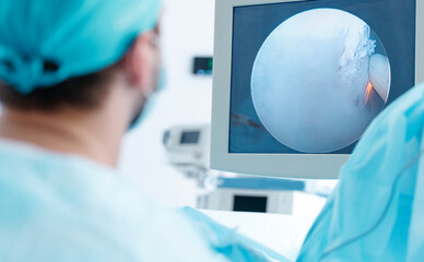 Male surgeon performing laparoscopy on prostate adenoma with surgical precision