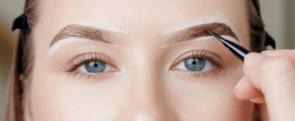 Expert eyebrow correction and tinting for young caucasian female, banner