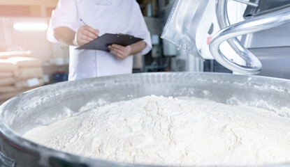 Dough mixing process in confectionery production line with quality assurance by pastry chef