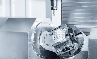 Five axis CNC machining center cutting engine turbine. Concept modern technology for industry