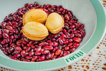 A bowl of vibrant red beans topped with traditional pastries creates a delightful contrast