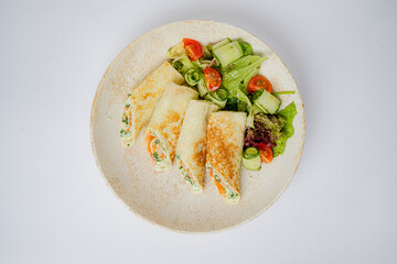Tasty wraps with colorful fillings, paired with a refreshing salad of greens and tomatoes