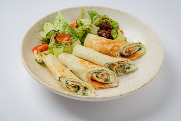 Savory vegetable and herb rolls are artfully arranged with a garden salad