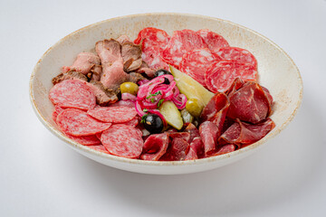 A stunning platter features cured meats and vibrant pickled veggies, showcasing culinary art