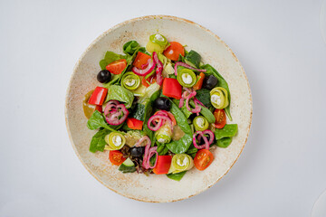 A fresh salad of greens, diced tomatoes, and colorful veggies, beautifully garnished