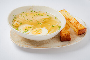 Cozy chicken broth with tender chicken, boiled eggs, and golden toast warms the heart