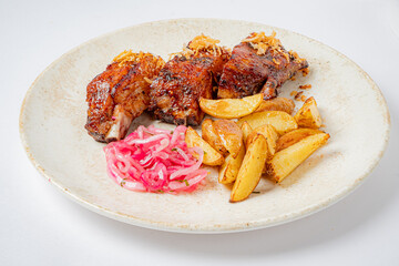 Grilled chicken, crispy potatoes, and tangy pickled onions make a mouthwatering meal