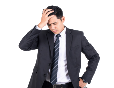 A man in a black suit and striped tie holds his head, appearing stressed or worried.
