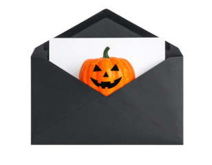 A black envelope contains a white card featuring a smiling Jack-o'-lantern pumpkin with triangular eyes and nose.