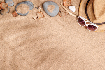 A tropical summer background featuring soft beach sand with delicate palm leaf shadows and sunhat