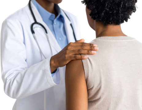 A doctor in a white coat reassures a patient by placing a hand on their shoulder during a consultation.