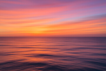 Obraz premium Vibrant orange pink purple sunset over calm ocean water, tranquil seascape reflecting colorful sky, peaceful horizon scene with rippling waves, scenic view of tropical dusk atmosphere and sea surface 