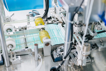Face mask factory, Surgical mask plant production line, Closeup machine conveyor belt roller in...