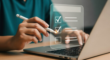 Completing digital checklist online survey form on laptop computer with stylus pen for task management