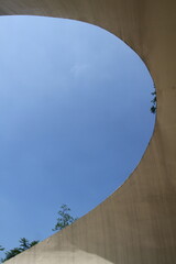 Low angle view of curve shape under blue sky during daytime.