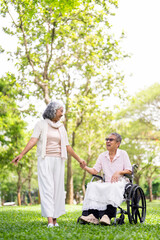 Senior, couple and people with disability in park for fresh air, walking and enjoyment of...