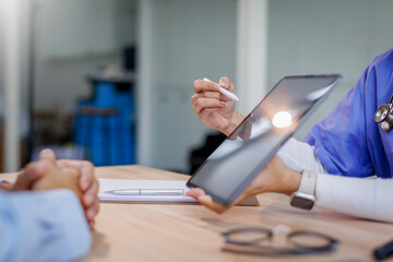 Doctor or nurse caregiver showing a tablet screen to senior man at home or nursing Tablet, screen...