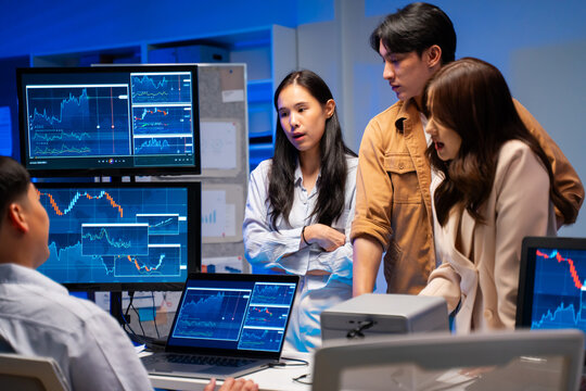 group of Happy young asian business people chatting happily after a night of overtime work in the office.Supervisor chats with employees after working together planning success strategy enjoy teamwork