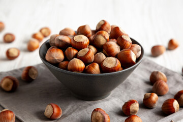 Organic Raw Hazelnuts in a Bowl, side view. Close-up.