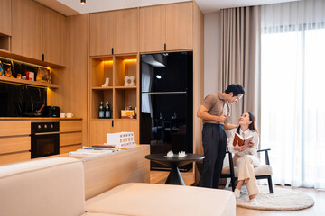 Young couple man and woman asian husband and wife in a relationship reading book hold books sits on...