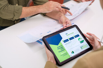 asian financial advisor presenting charts and data on a tablet during couple client meeting.financial planning and decision-making