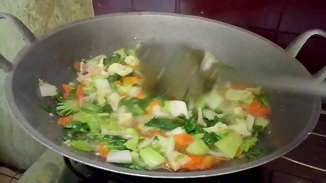 Cooking Asian Stir-Fry Vegetable Soup in a Wok